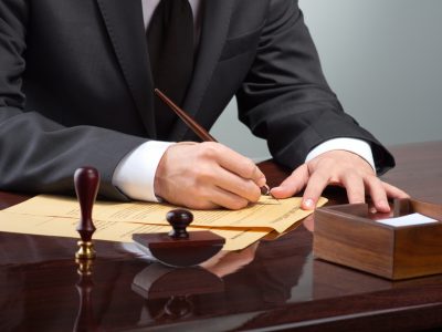 Businessman writing testament at notary public office